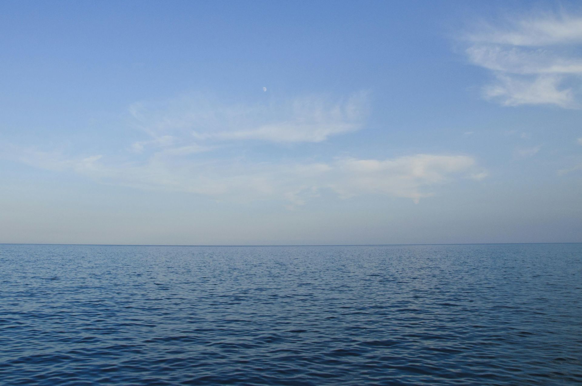 Calm ocean view with clear blue sky, perfect for backgrounds or wallpapers.