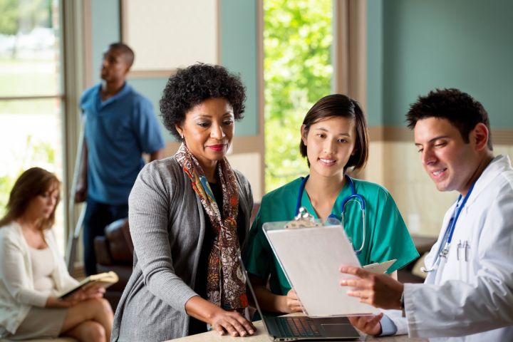 Three healthcare professionals who need help with their marketing because they are at work with their patients.